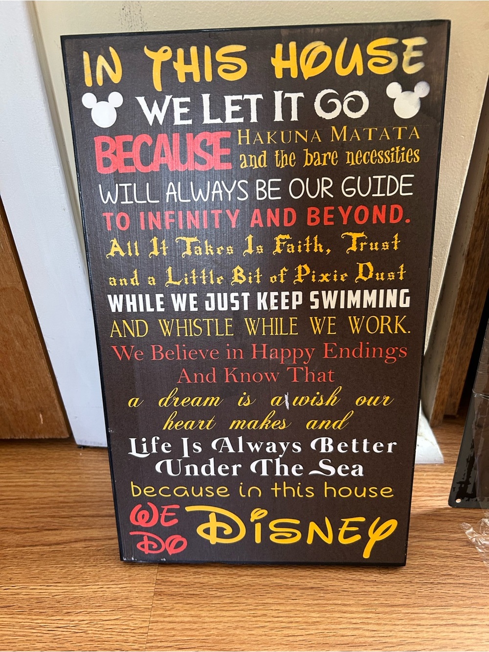 In This House We Do Disney Wall Art - Yellow, Red, White Text on Brown